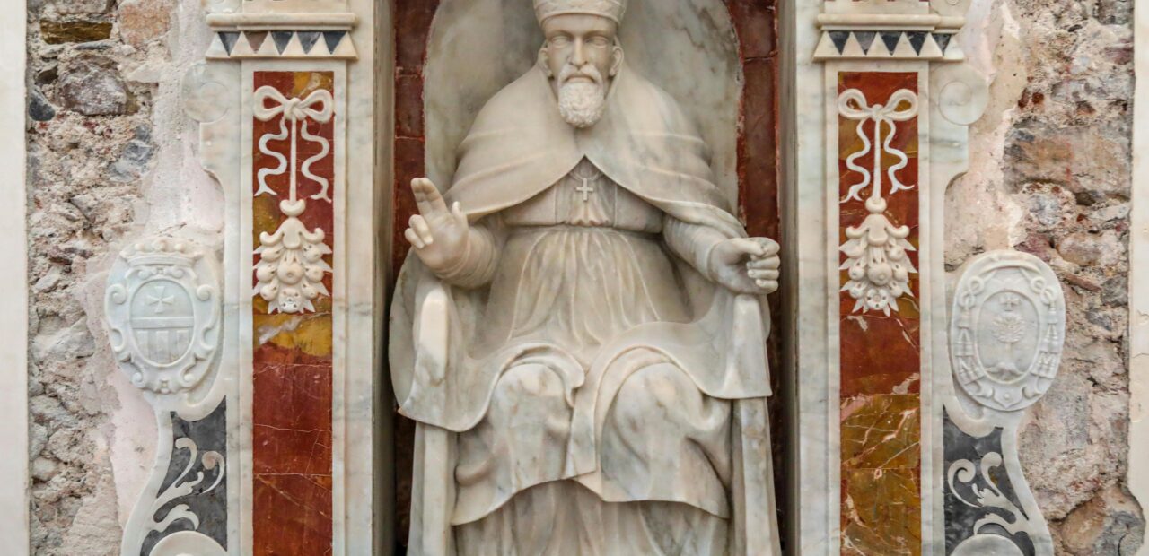 Beautiful marble sculpture of a pope in a historic Sicilian church, highlighting Italy's rich cultural heritage.
