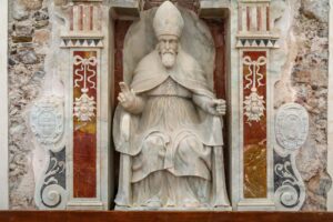 Beautiful marble sculpture of a pope in a historic Sicilian church, highlighting Italy's rich cultural heritage.