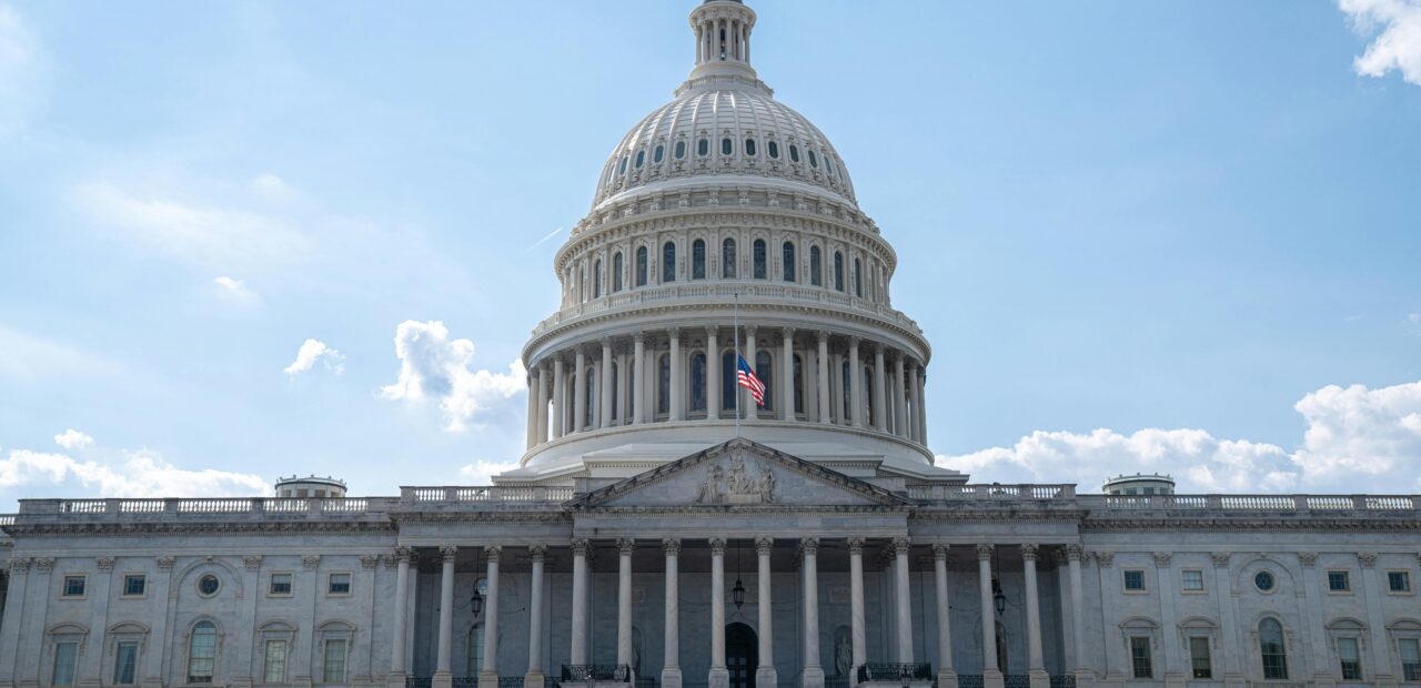 Stunning architectural shot of the US Capitol under a clear blue sky.