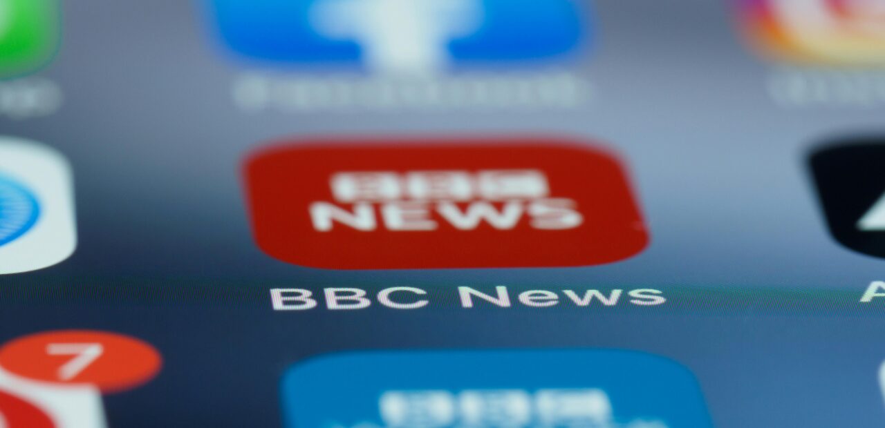 Macro shot of a smartphone screen displaying the BBC News app icon and notifications.